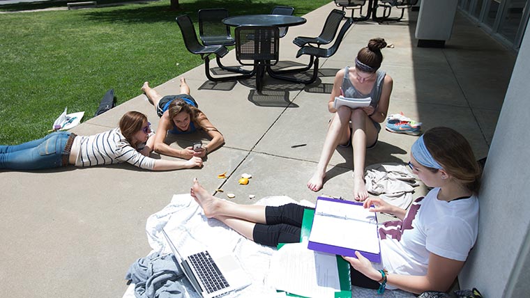Students studying outside of residence hall.