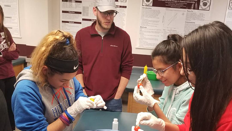 Middle school girls doing hands-on activity at Expanding Your Horizons event.