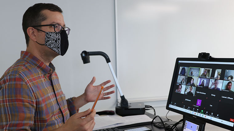 A Missouri State professor teaching a blended psychology class - Zoom and seated. 