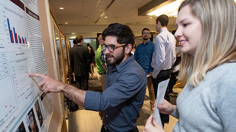 Students looking at poster.